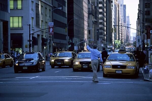 Main hailing taxi in downtown Manhattan