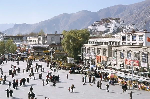 Main square in front of Jokhang, Potala palace beyond, Lhasa, Tibet, China, Asia