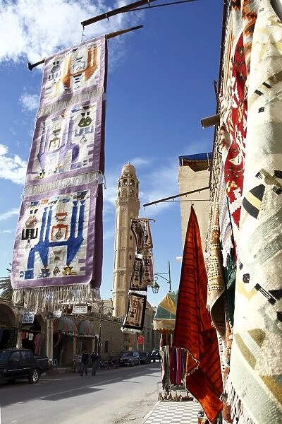 Main street with mosque and carpet shop display, Tozeur, Tunisia, North Africa, Africa