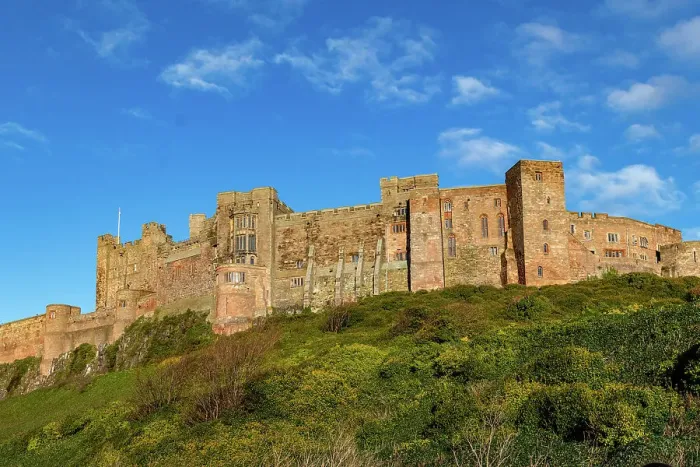 Framed Print : Majestic medieval castle on a hill with lush greenery under a clear blue sky, Bamburgh, Northumberland, England, United Kingdom, Europe Framed Print : Majestic medieval castle on a hill with lush greenery under a clear blue sky, Bamburgh, Northumberland, England, United Kingdom, Europe