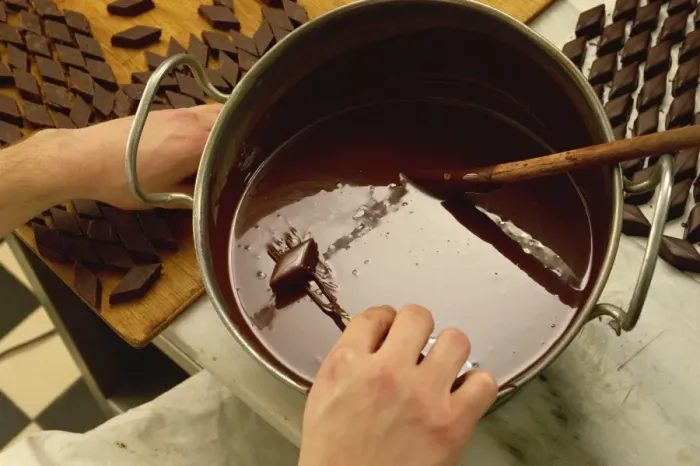 Framed Print : Making chocolates by hand
