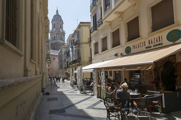 Malaga Cathedral and cafe in narrow street, Malaga, Costa del Sol, Andalusia, Spain