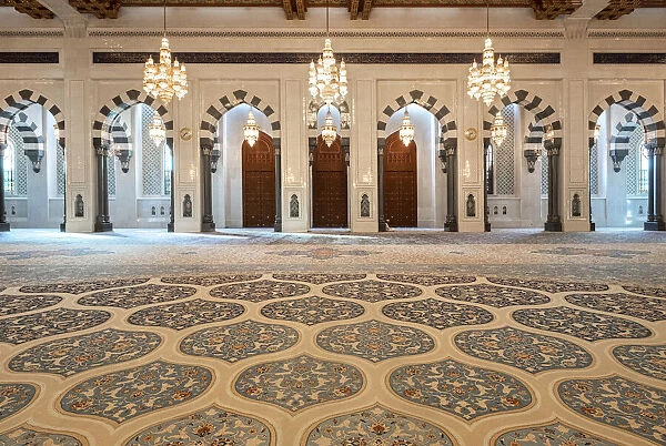 Male praying room of the Sultan Qaboos Mosque with decorated carpet and many arches