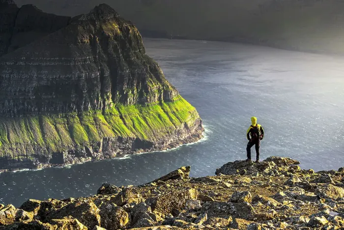 Framed Print : One man admiring the majestic cliffs along a fjord standing on top of mountain during a hike, Vidoy Island, Faroe Islands, Denmark, Europe Framed Print : One man admiring the majestic cliffs along a fjord standing on top of mountain during a hike, Vidoy Island, Faroe Islands, Denmark, Europe