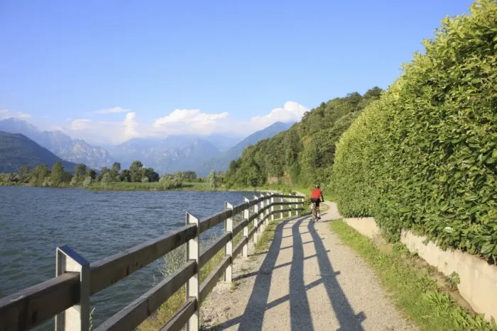 Framed Print : Man bikes along path at lakes edge, Lake Como, Italian Lakes, Lombardy