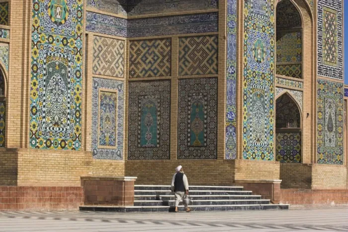 Framed Print : A man carrying a kettle walks past the Friday Mosque (Masjet-e Jam) (Masjid-e Jam) Framed Print : A man carrying a kettle walks past the Friday Mosque (Masjet-e Jam) (Masjid-e Jam)