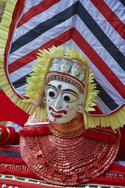 Man in costume representing a god at the Teyyam ceremony, near Kannur, Kerala, India, Asia