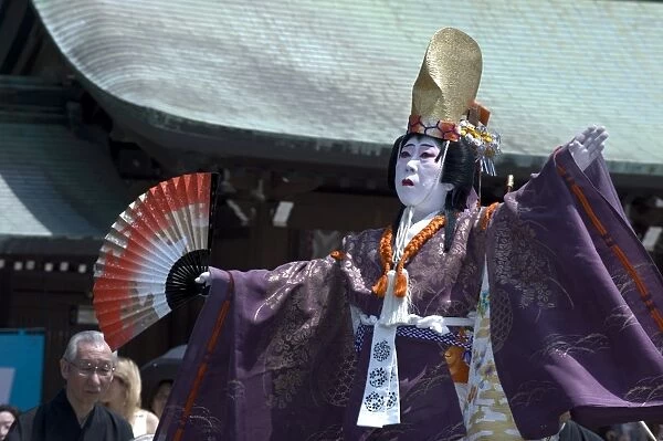 Man dressed as a woman performing classical Japanese dance called hobu at Meiji Jingu shrine