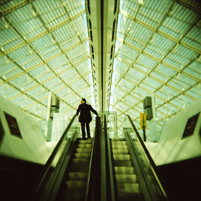 Framed Print : Man on escalator, Charles de Gaulle Airport, Paris, France, Europe Framed Print : Man on escalator, Charles de Gaulle Airport, Paris, France, Europe