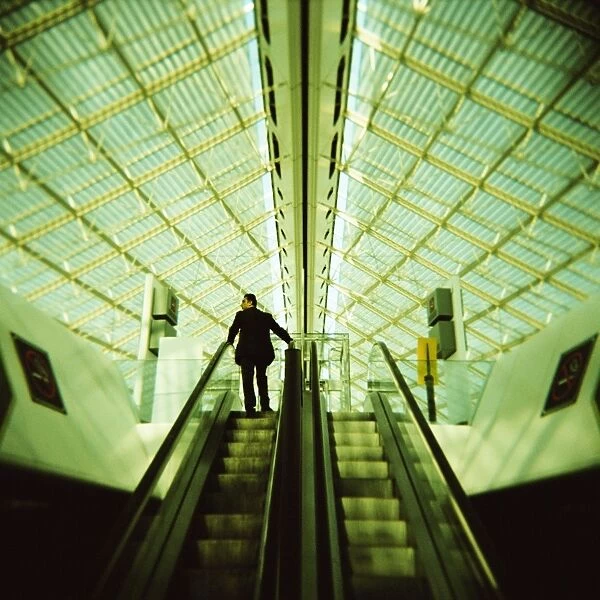 Man on escalator, Charles de Gaulle Airport, Paris, France, Europe