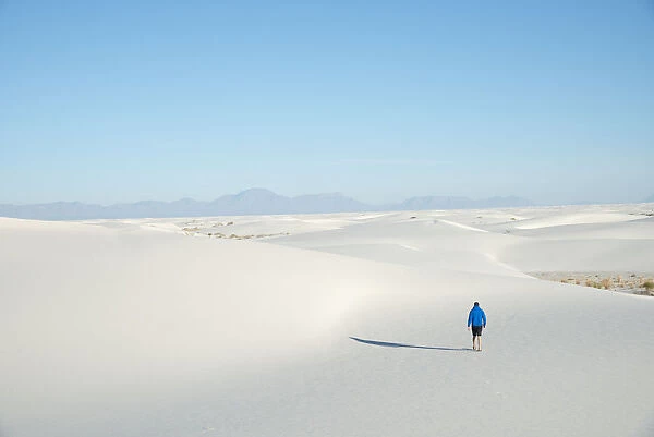 A man exploring the vast landscape of White Sands National Park, New Mexico