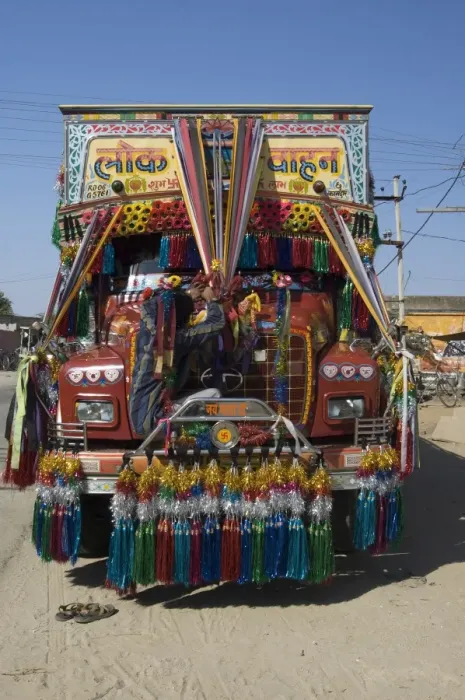 Framed Print : Man fixing decoration onto truck for Diwali celebrations, Pali district Framed Print : Man fixing decoration onto truck for Diwali celebrations, Pali district