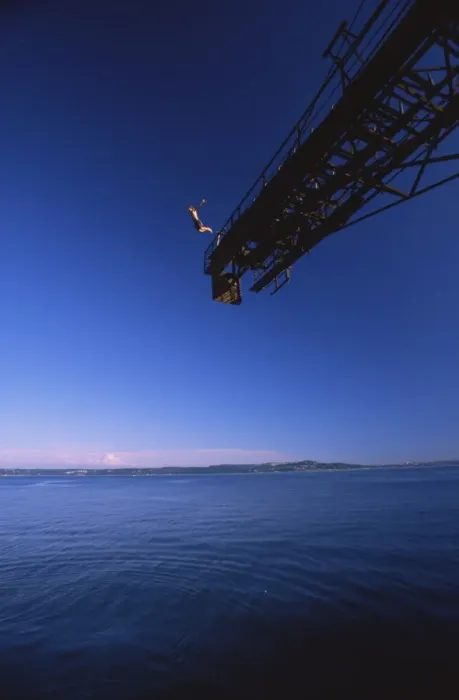 Framed Print : Man jumping from a crane, Washington State, United States of America, North America Framed Print : Man jumping from a crane, Washington State, United States of America, North America