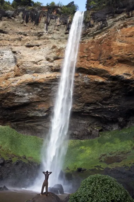 Framed Print : A man looks up at Sipi Falls, Uganda, East Africa, Africa Framed Print : A man looks up at Sipi Falls, Uganda, East Africa, Africa