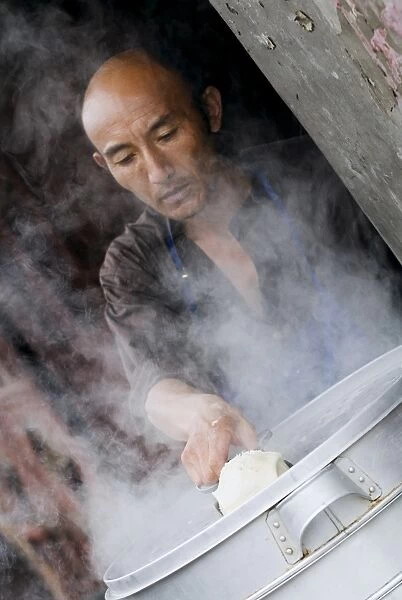 Man making Baozi (dumplings), Dali old town, Dali, Yunnan, China, Asia