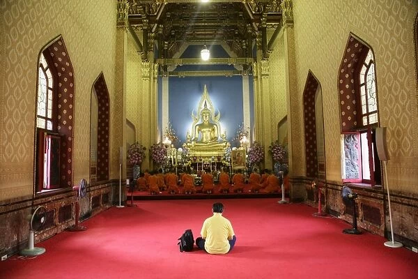 Man and monks praying