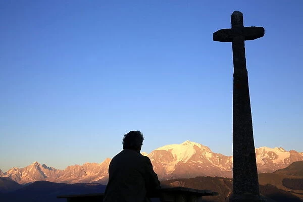 Man praying in front of Mont Blanc, Megeve, Haute-Savoie, France, Europe