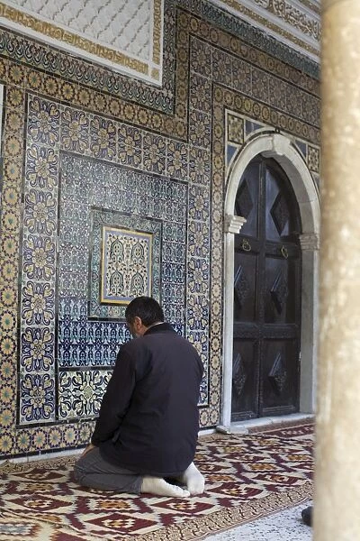Man praying at the mosque in the suk of the Medina, Tripoli, Libya, North Africa, Africa