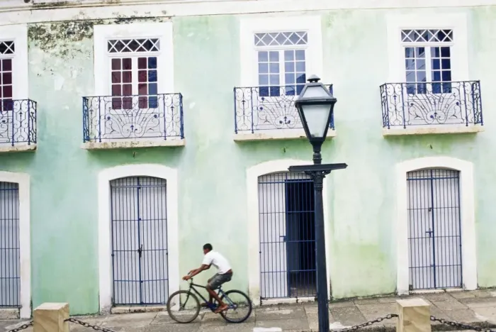 Framed Print : Man riding bicycle in front of old colonial house, Sao Luis, Maranhao, Brazil Framed Print : Man riding bicycle in front of old colonial house, Sao Luis, Maranhao, Brazil