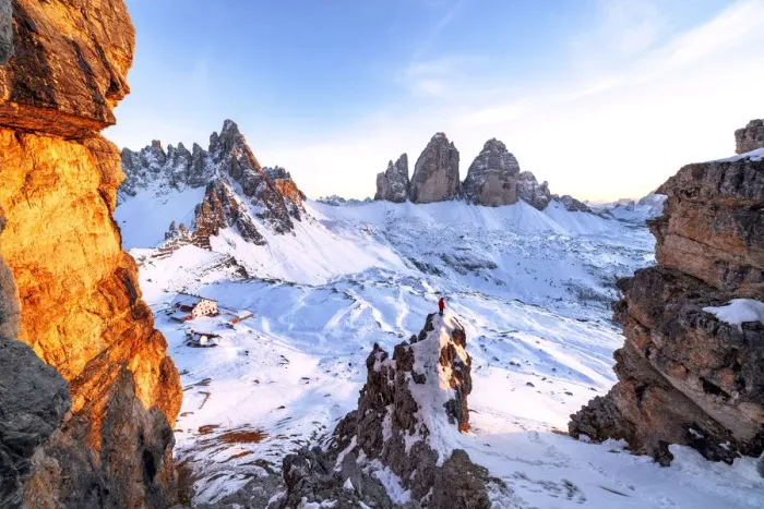 Framed Print : Man on rocks admiring the snowy Monte Paterno and Tre Cime di Lavaredo at sunset Framed Print : Man on rocks admiring the snowy Monte Paterno and Tre Cime di Lavaredo at sunset