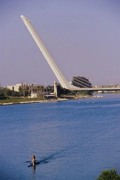 Man rowing with Barquetta bridge in the background