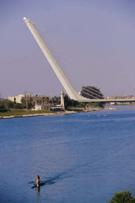 Framed Print : Man rowing with Barquetta bridge in the background Framed Print : Man rowing with Barquetta bridge in the background