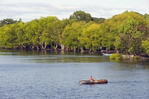 Man rowing a boat on Ometepe Island, Lake Nicaragua, Nicaragua, Central America