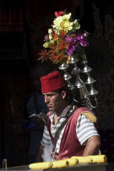 Man selling tea in traditional costume
