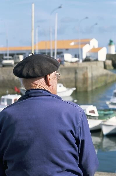 Man sitting on the quayside, Port Joinville Commune, Ile d Yeu, Vendee