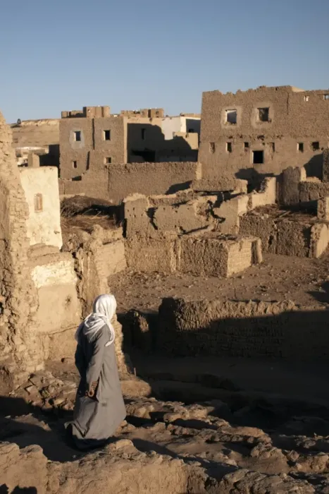 Framed Print : A man stands among the ruin of the mud-brick city of Al-Qasr, Dakhla Oasis Framed Print : A man stands among the ruin of the mud-brick city of Al-Qasr, Dakhla Oasis