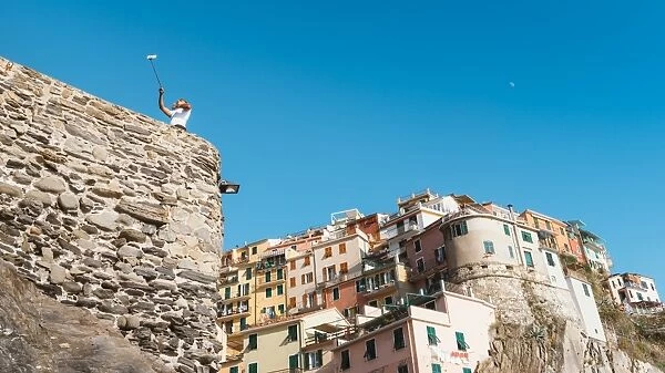 A man taking a selfie at Manarola, Cinque Terre, UNESCO World Heritage Site, Liguria