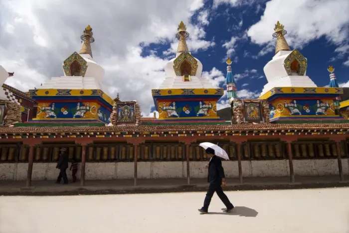 Framed Print : Man with umbrella at temple, Yushu, Qinghai, China, Asia Framed Print : Man with umbrella at temple, Yushu, Qinghai, China, Asia