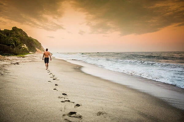 Man walking on the beach in Tayrona National Park, Colombia, South America