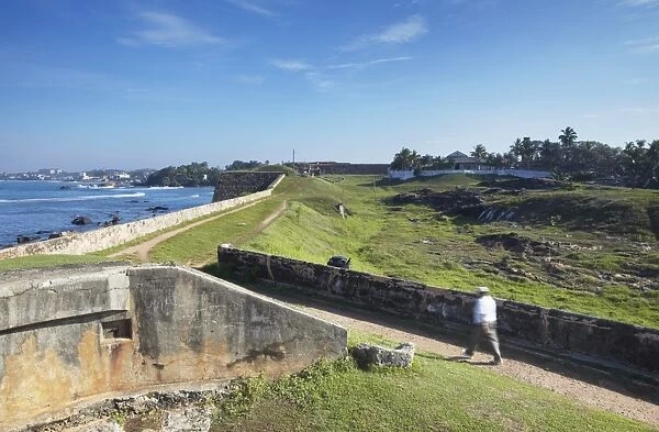Man walking on Fort ramparts, Galle, UNESCO World Heritage Site, Southern Province, Sri Lanka, Asia