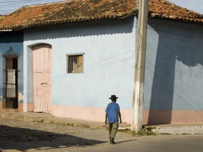 Framed Print : A man walking past colourfully painted houses in Trinidad, UNESCO World Heritage Site Framed Print : A man walking past colourfully painted houses in Trinidad, UNESCO World Heritage Site