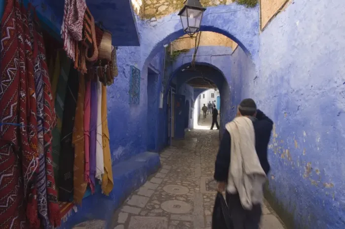 Framed Print : Man walking through pastel coloured streets of Chefchaouen Framed Print : Man walking through pastel coloured streets of Chefchaouen