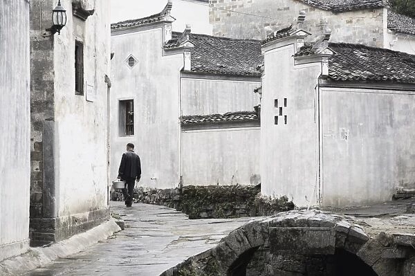 Man walking in the street, Xi Di (Xidi) village, UNESCO World Heritage Site