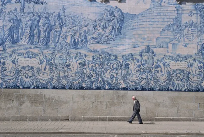 Framed Print : Man walks by the azulejo tile panel of the Carmo church in Oporto Framed Print : Man walks by the azulejo tile panel of the Carmo church in Oporto