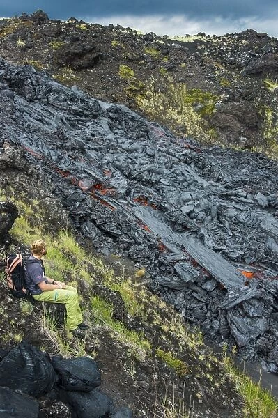 Man watching an active lava stream, Tolbachik volcano, Kamchatka, Russia, Eurasia