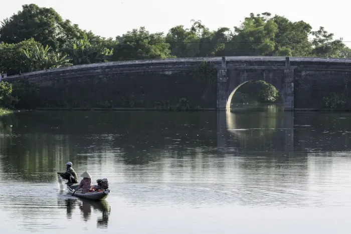 Framed Print : A man and woman fishing from a small boat in the moat around the Citadel in Hue, Vietnam Framed Print : A man and woman fishing from a small boat in the moat around the Citadel in Hue, Vietnam