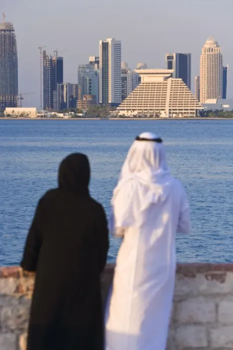 Framed Print : Man and woman in traditional dress looking across Doha Framed Print : Man and woman in traditional dress looking across Doha