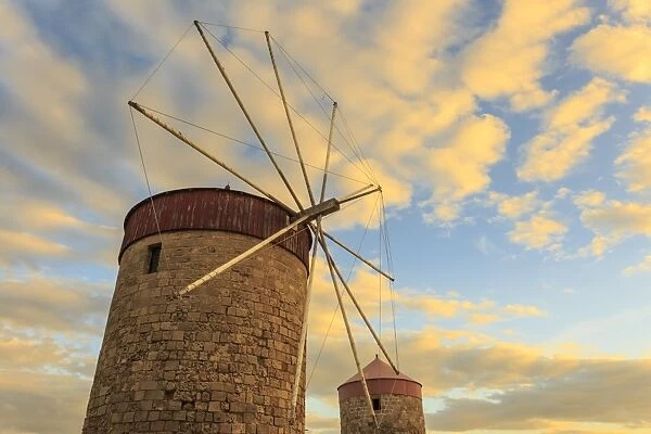 Mandraki Harbour medieval windmills at sunset, Rhodes, Dodecanese, Greek Islands