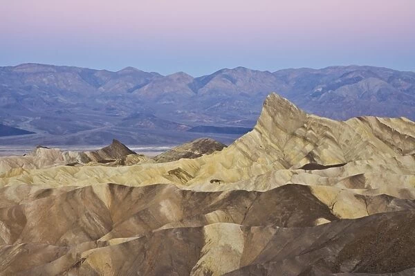 Manly Beacon and the Siltstone eroded foothills formations at Zabriske Point at sunrise