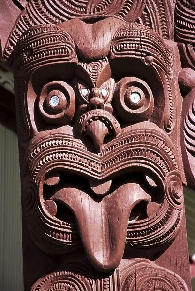 Maori wooden carving with tongue sticking out