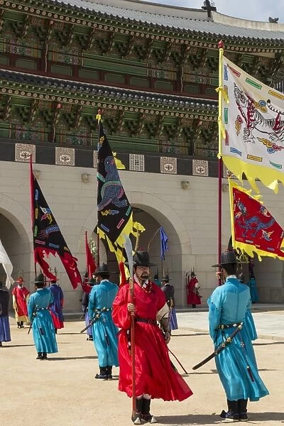 Marching with flags at Gwanghwamun gate, colourful Changing of the Guard Ceremony