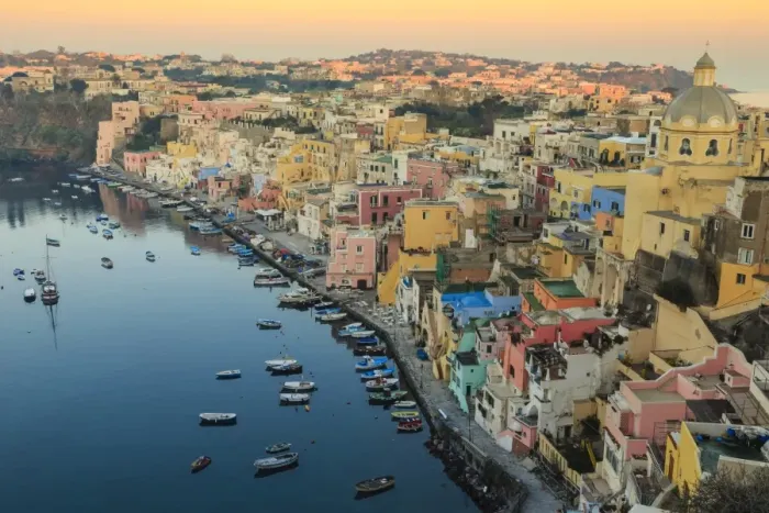 Framed Print : Marina Corricella at sunrise, fishing village, colourful houses, church and harbour boats Framed Print : Marina Corricella at sunrise, fishing village, colourful houses, church and harbour boats