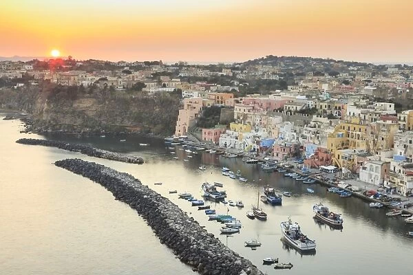 Marina Corricella sunset, fishing village, colourful fishermens houses, boats and church