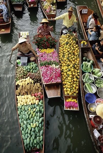 Market traders in boats selling flowers and fruit