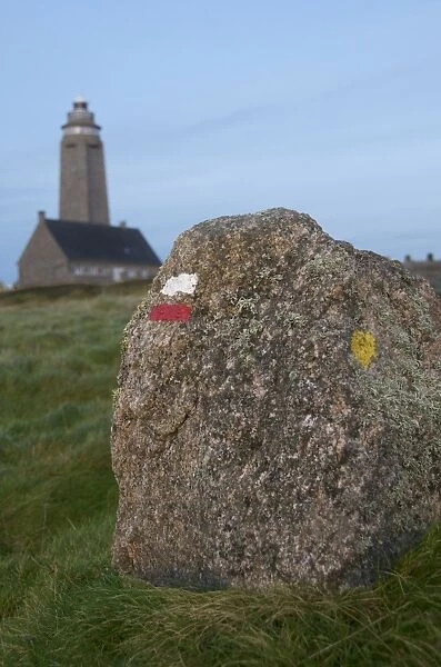 Markings on rock for cross country walkers, and lighthouse in the background