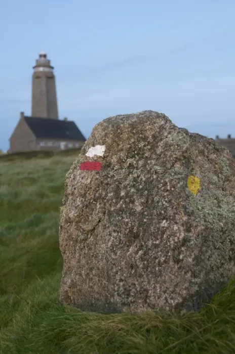 Framed Print : Markings on rock for cross country walkers, and lighthouse in the background Framed Print : Markings on rock for cross country walkers, and lighthouse in the background